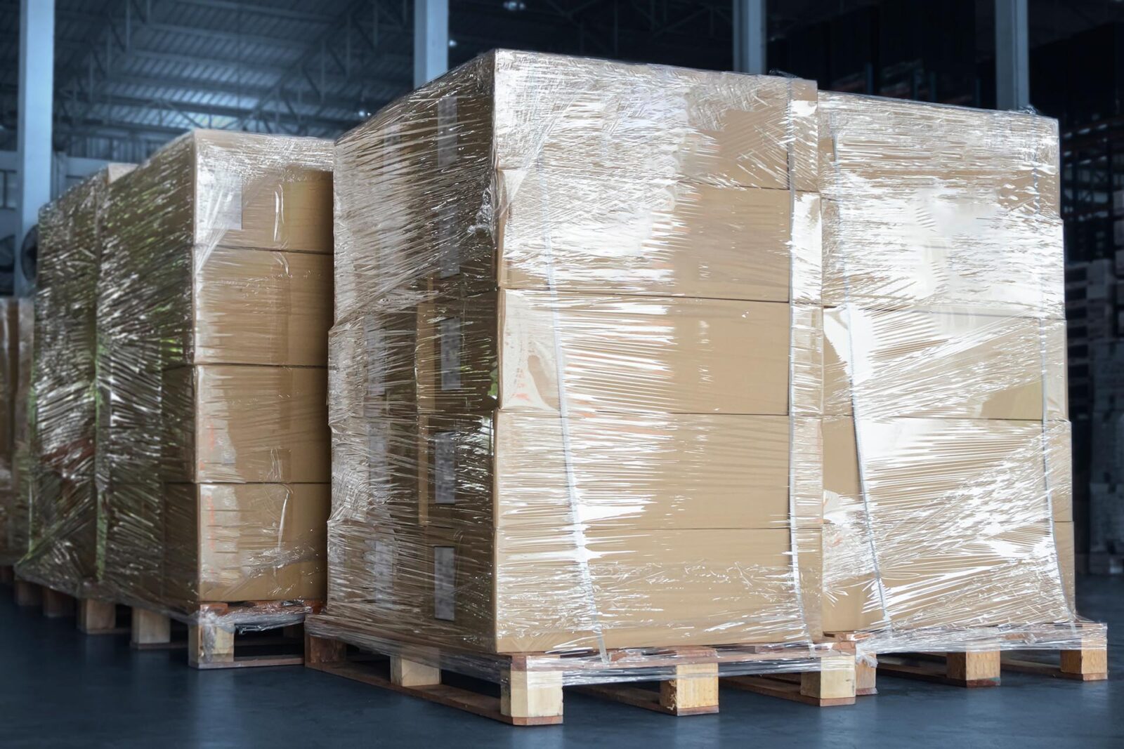 Stacked,Of,Cardboard,Boxes,Wrapped,Plastic,On,Pallet,Rack.,Interior